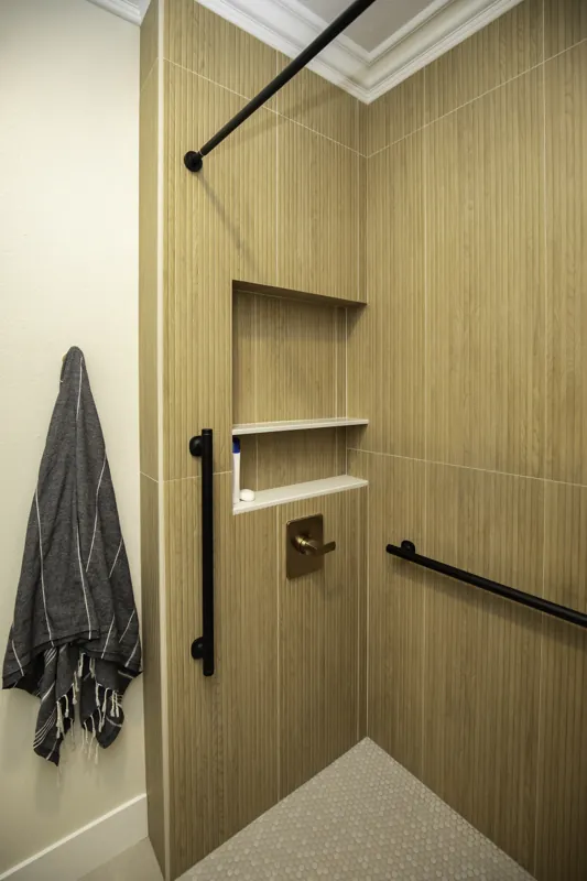 Tiled shower with niche and brass fixtures