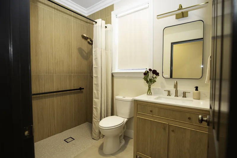 Bathroom vanity with wood-look shower wall tile and mosaic floor