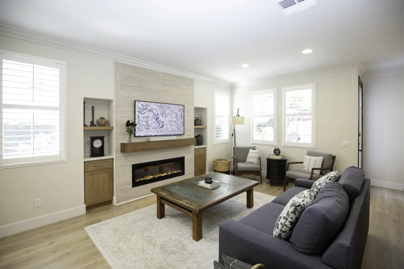 Living room with tiled fireplace surround and wood mantel