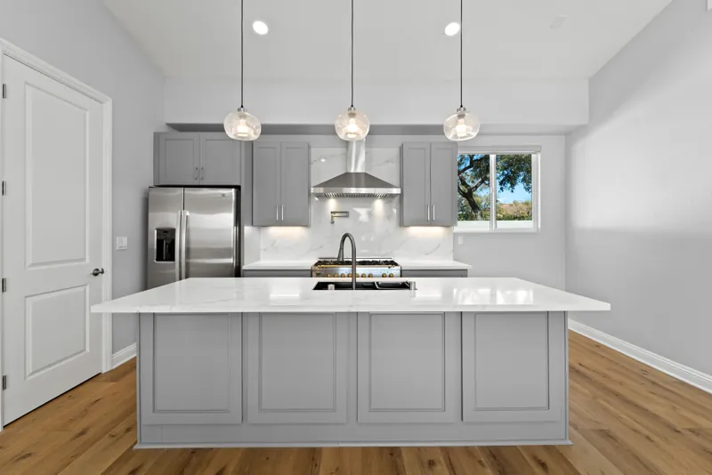 Kitchen island viewed toward the range and refrigerator